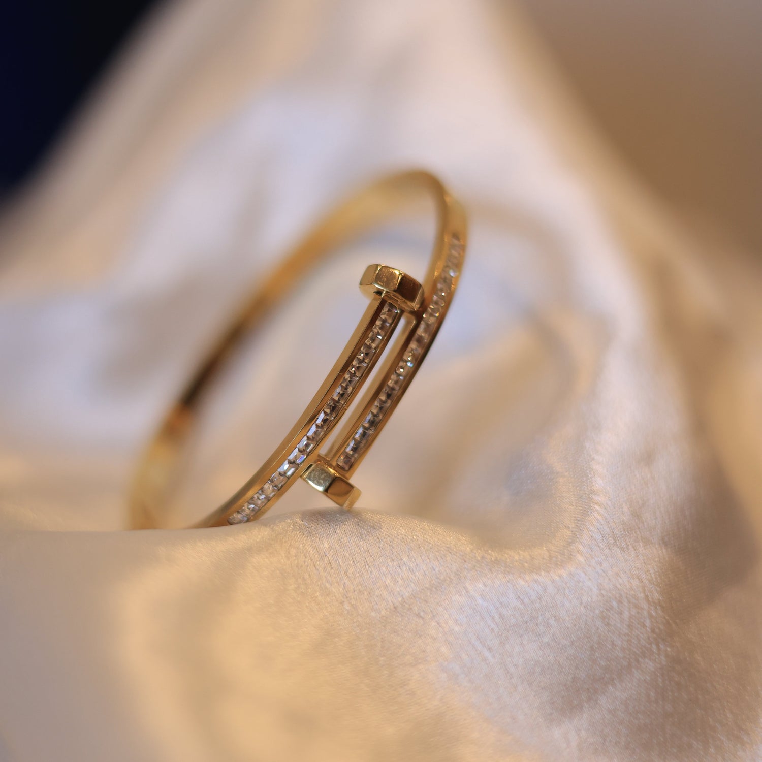 Gold bracelet on a soft fabric surface