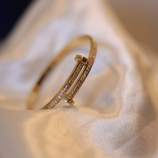 Gold bracelet on a soft fabric surface